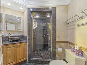 Full bath with crown molding, vanity, a shower stall, and recessed lighting