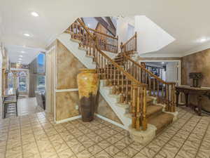 Staircase featuring ornamental molding, recessed lighting, and tile patterned flooring