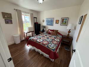 Bedroom with wood finished floors and a textured ceiling