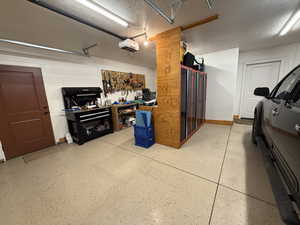 Garage featuring a workshop area and a garage door opener