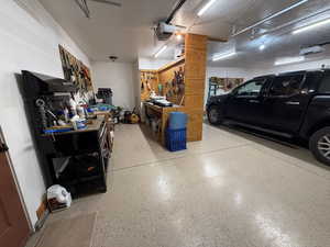 Garage featuring a workshop area and a garage door opener