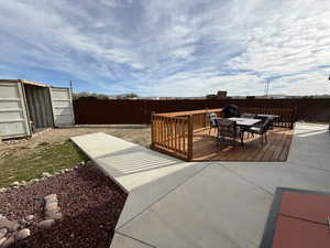 Deck with outdoor dining area and a fenced backyard