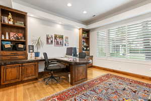 Office area featuring light wood-style flooring, recessed lighting, and built in study area