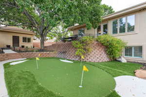 View of yard featuring a putting green and a patio area