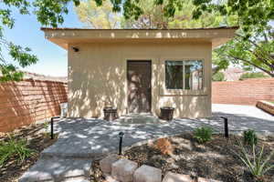 Entrance to property with a patio area and stucco siding