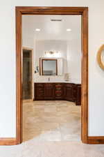 Full bathroom with vanity, a stall shower, recessed lighting, and light tile patterned floors