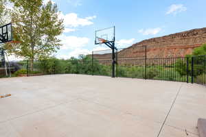 View of sport court featuring basketball court and a patio