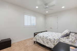 Bedroom featuring carpet floors, recessed lighting, a ceiling fan, and a closet