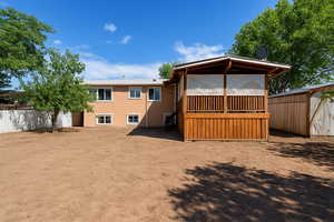 Rear view of property with stucco siding
