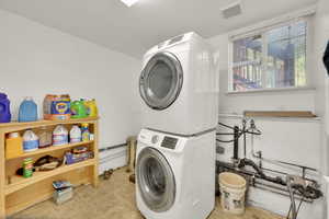 Laundry room featuring estacked washer and dryer