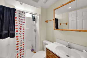 Bathroom featuring vanity, a shower with shower curtain, and recessed lighting