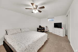 Bedroom featuring light carpet and a ceiling fan