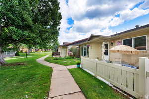 View of side of property featuring a wooden deck
