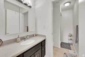 Bathroom with light tile patterned flooring and vanity