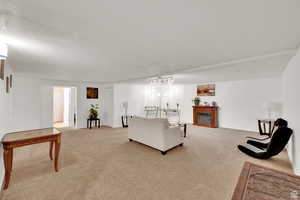 Living area with light colored carpet and a fireplace