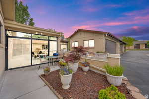 View of front of property with brick siding and a patio area