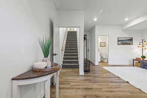 Entry, living room, garage access, and stairs to main living area.