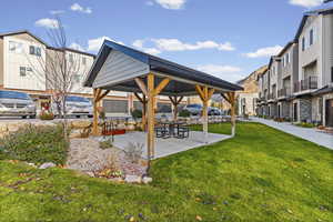 View of home's community featuring a patio area/pavilion, a residential view, and a yard
