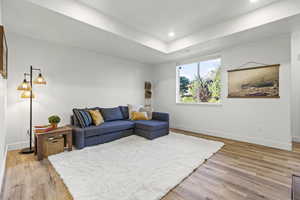 Living room with light wood-style floors and recessed lighting