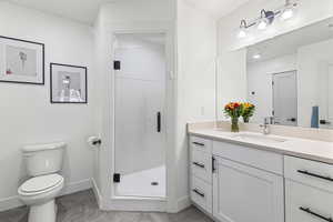 Primary bathroom featuring a stall shower, and vanity