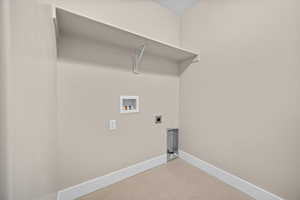 Laundry room with washer hookup, hookup for an electric dryer, and concrete floors