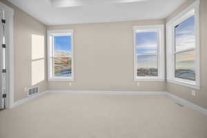Carpeted empty room featuring baseboards