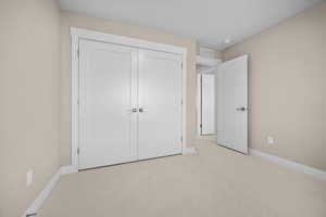 Unfurnished bedroom with carpet and a closet
