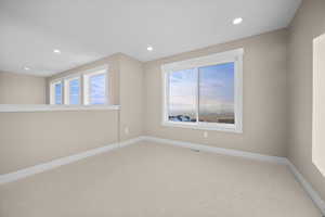 Empty room with recessed lighting and carpet floors