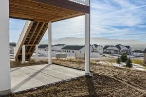 View of patio / terrace featuring a residential view, stairs, and a deck with mountain view