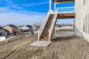 View of yard with a residential view, stairs, and a patio