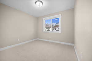 Unfurnished room with baseboards and carpet