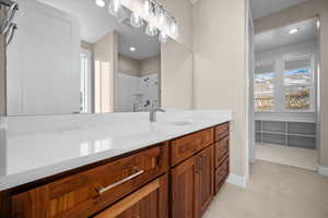 Full bathroom featuring a stall shower, vanity, and recessed lighting