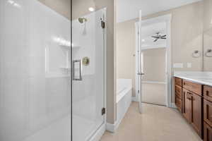 Full bath featuring vanity, a bath, a stall shower, and ceiling fan