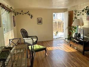 Sitting room with wood-type flooring