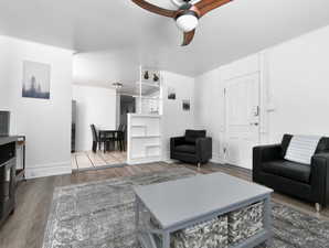 Living room with wood finished floors and a ceiling fan
