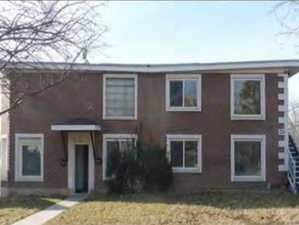 Colonial home with a front yard and stairs