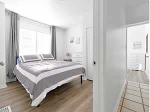 Bedroom featuring a textured ceiling and light wood-type flooring