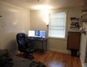 Office space with wood finished floors and baseboards