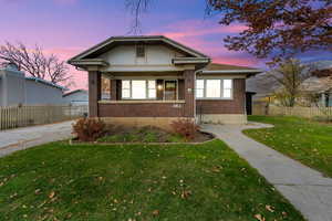 Bungalow-style home featuring brick siding and covered porch