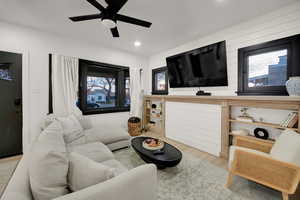 Living area with plenty of natural light, wood finished floors, recessed lighting, and a ceiling fan