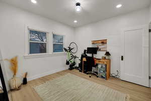Home office featuring light wood-style floors and recessed lighting