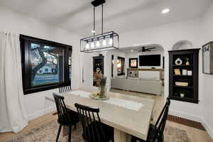 Dining room with a ceiling fan, light wood-style floors, and recessed lighting