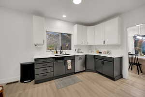 Kitchen with white cabinets, gray cabinetry, decorative backsplash, dishwasher, and recessed lighting