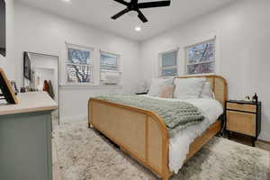 Bedroom with ceiling fan, recessed lighting, and cooling unit