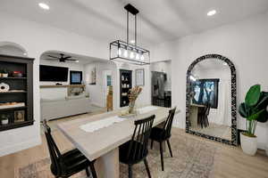 Dining area featuring arched walkways, recessed lighting, light wood-type flooring, and ceiling fan