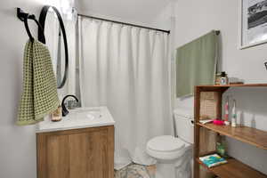 Full bath with vanity and curtained shower