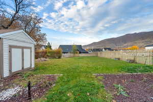 View of yard with a shed and a mountain view
