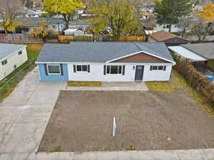 Single story home featuring roof with shingles, concrete driveway, and a residential view