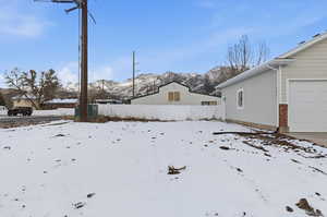 Yard covered in snow with a mountain view