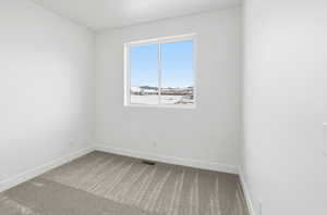 Empty room with carpet floors and baseboards